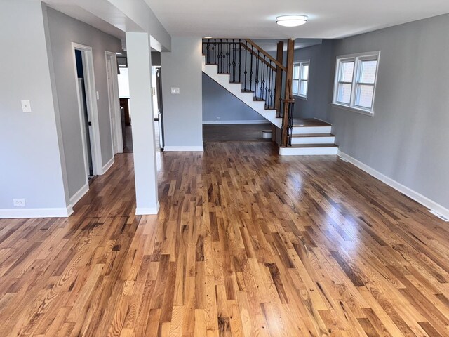7032 W 63rd Pl, Chicago, IL 60638 - unfurnished living room with stairway and wood finished floors
