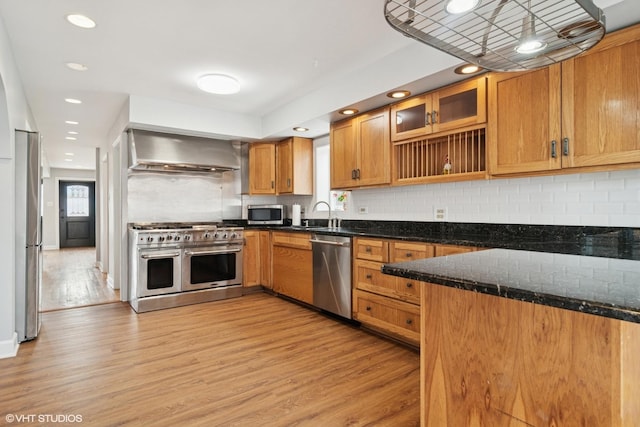 7032 W 63rd Pl, Chicago, IL 60638 - kitchen featuring appliances with stainless steel finishes, wall chimney range hood, healthy amount of natural light, light wood-style floors, and recessed lighting