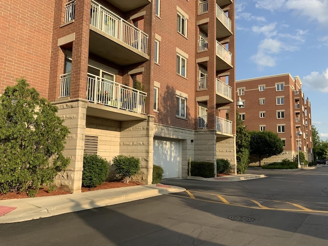 6560 W Diversey Ave Unit 417, Chicago, IL 60707 - view of apartment building / complex featuring an attached garage