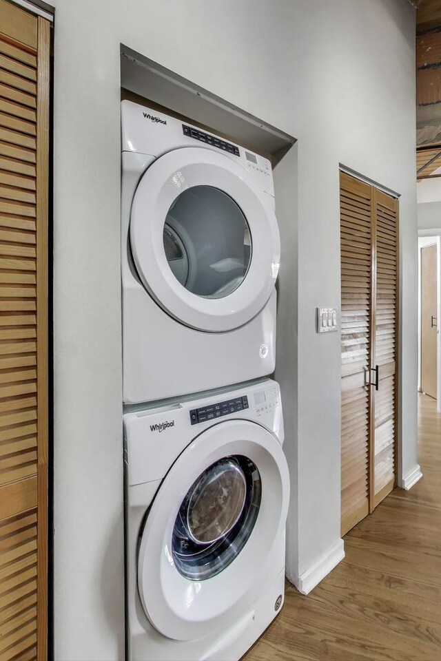 2310 S Canal St Unit 401, Chicago, IL 60616 - laundry room with estacked washer and dryer and wood finished floors