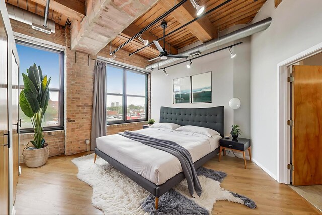 2310 S Canal St Unit 401, Chicago, IL 60616 - bedroom featuring rail lighting, brick wall, wooden ceiling, and light wood finished floors