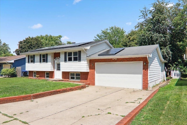 1209 Gettysburg Dr, Bloomington, IL 61704 - bi-level home featuring driveway, a front lawn, roof mounted solar panels, and an attached garage