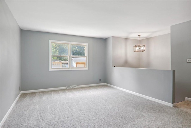1209 Gettysburg Dr, Bloomington, IL 61704 - carpeted empty room featuring a chandelier and baseboards