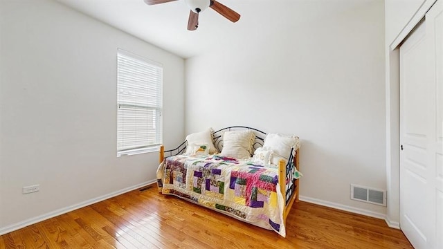 3201 Rockwell Cir, Mundelein, IL 60060 - bedroom with wood finished floors, multiple windows, ceiling fan, and a closet