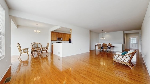 3201 Rockwell Cir, Mundelein, IL 60060 - living room featuring a chandelier and light wood-type flooring