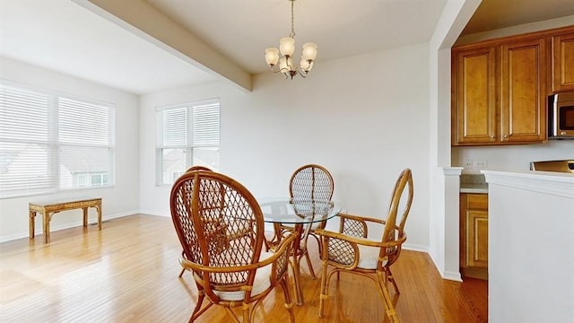 3201 Rockwell Cir, Mundelein, IL 60060 - dining area featuring light wood-style floors, beamed ceiling, and a chandelier