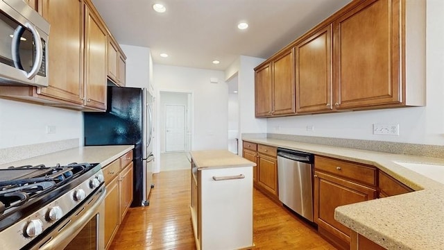 3201 Rockwell Cir, Mundelein, IL 60060 - kitchen with stainless steel appliances, light wood-type flooring, light countertops, recessed lighting, and brown cabinets
