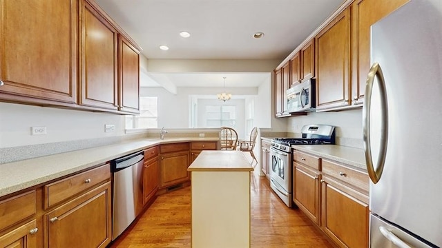 3201 Rockwell Cir, Mundelein, IL 60060 - kitchen featuring stainless steel appliances, light wood finished floors, light countertops, recessed lighting, and a kitchen island