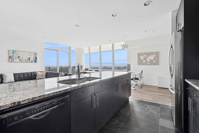 737 W Washington Blvd Unit 3308, Chicago, IL 60661 - kitchen featuring black dishwasher, open floor plan, light stone countertops, freestanding refrigerator, and dark cabinets