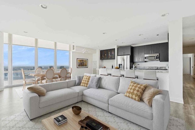737 W Washington Blvd Unit 3308, Chicago, IL 60661 - living room featuring plenty of natural light, light wood finished floors, floor to ceiling windows, and recessed lighting