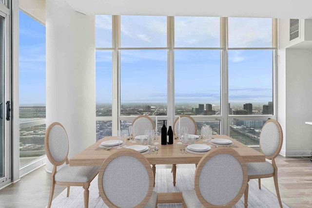 737 W Washington Blvd Unit 3308, Chicago, IL 60661 - dining area featuring wood finished floors, plenty of natural light, floor to ceiling windows, and a city view