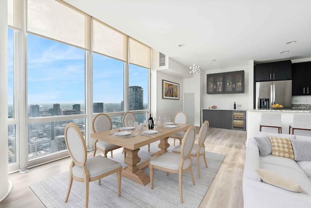 737 W Washington Blvd Unit 3308, Chicago, IL 60661 - dining room with a wall of windows, light wood-style flooring, a city view, and a chandelier