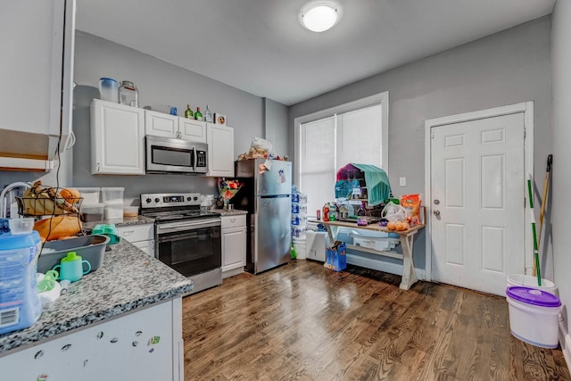 4251 W Jackson Blvd, Chicago, IL 60624 - kitchen with stainless steel appliances, white cabinets, light wood-style flooring, and light stone countertops