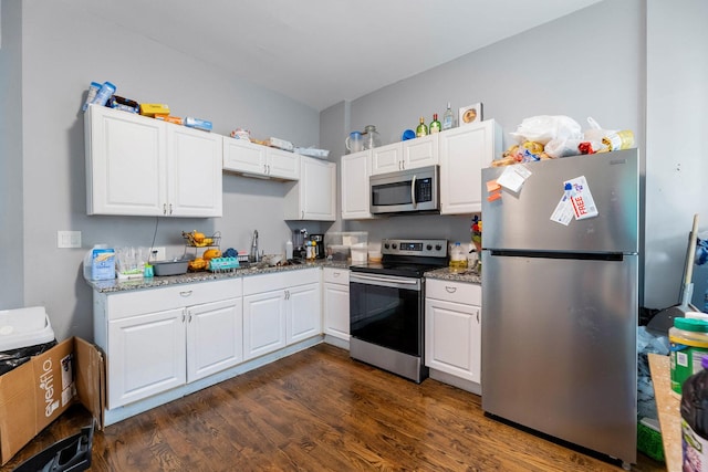 4251 W Jackson Blvd, Chicago, IL 60624 - kitchen with stainless steel appliances, dark wood-style flooring, white cabinets, and light stone counters