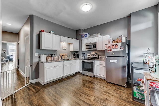 4251 W Jackson Blvd, Chicago, IL 60624 - kitchen with stainless steel appliances, dark wood-style flooring, and white cabinets