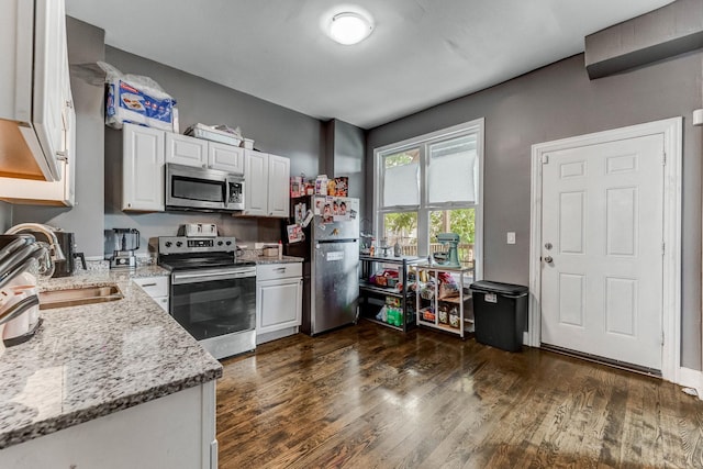 4251 W Jackson Blvd, Chicago, IL 60624 - kitchen with stainless steel appliances, white cabinets, light stone counters, and dark wood-style flooring
