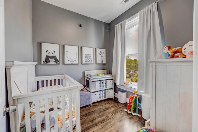 4251 W Jackson Blvd, Chicago, IL 60624 - bedroom featuring wood finished floors and a crib