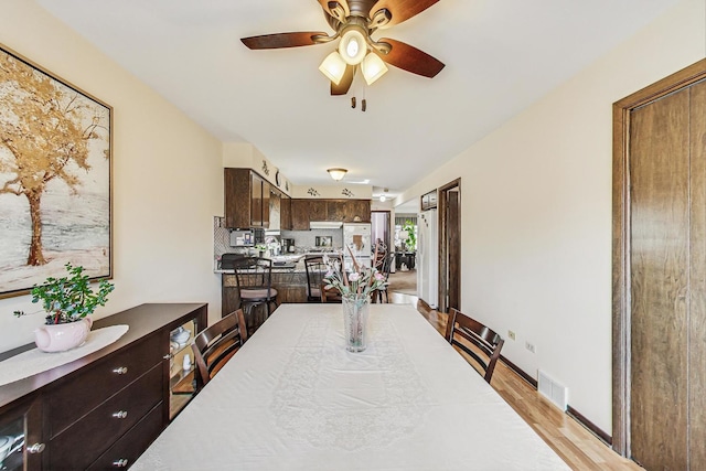 11531 S S Ave J, Chicago, IL 60617 - dining room with ceiling fan and light wood-style floors