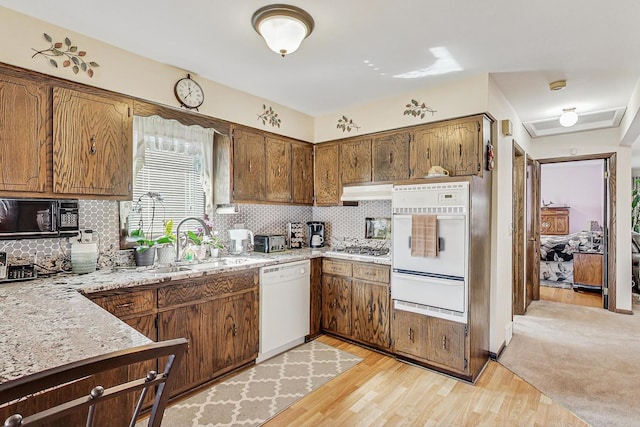 11531 S S Ave J, Chicago, IL 60617 - kitchen featuring white appliances, a warming drawer, a sink, tasteful backsplash, and light wood-style flooring