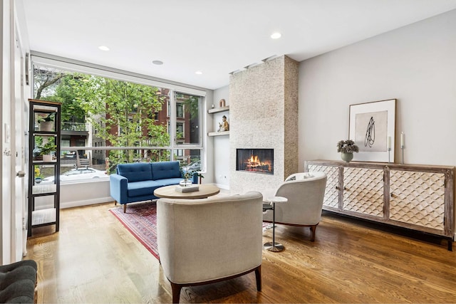 874 N Marshfield Ave Unit 1, Chicago, IL 60622 - living area featuring wood finished floors, a large fireplace, built in shelves, and recessed lighting