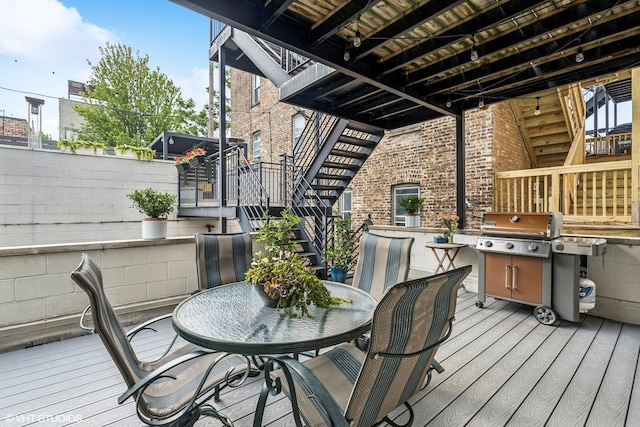 874 N Marshfield Ave Unit 1, Chicago, IL 60622 - deck featuring stairs, outdoor dining area, and a grill