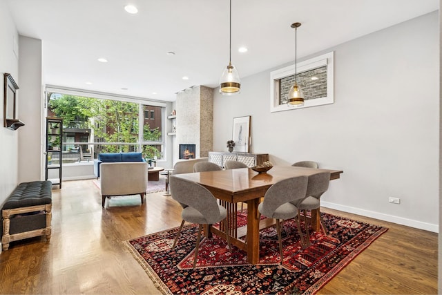874 N Marshfield Ave Unit 1, Chicago, IL 60622 - dining area with wood finished floors, recessed lighting, and a large fireplace