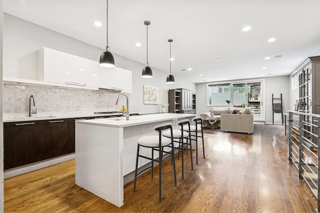 874 N Marshfield Ave Unit 1, Chicago, IL 60622 - kitchen featuring modern cabinets, dark brown cabinets, white cabinets, light countertops, and backsplash