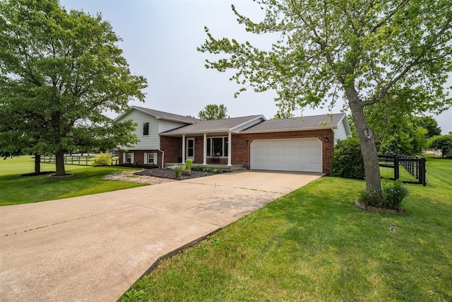 107 W 10th St, Gridley, IL 61744 - tri-level home featuring a garage, brick siding, concrete driveway, and a front yard