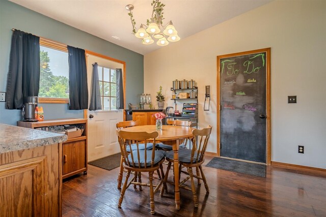 107 W 10th St, Gridley, IL 61744 - dining space featuring a chandelier, dark wood-style flooring, and vaulted ceiling