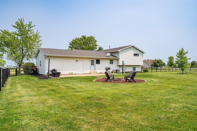 107 W 10th St, Gridley, IL 61744 - rear view of house featuring a fenced backyard, a fire pit, and a patio
