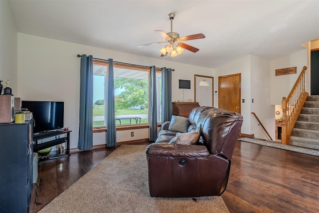 107 W 10th St, Gridley, IL 61744 - living area featuring wood finished floors, ceiling fan, and stairway