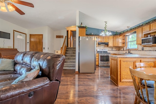107 W 10th St, Gridley, IL 61744 - kitchen with appliances with stainless steel finishes, open floor plan, vaulted ceiling, under cabinet range hood, and open shelves