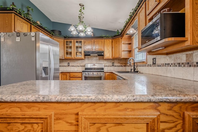 107 W 10th St, Gridley, IL 61744 - kitchen featuring appliances with stainless steel finishes, open shelves, under cabinet range hood, vaulted ceiling, and decorative backsplash
