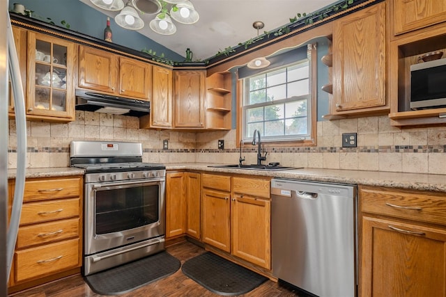 107 W 10th St, Gridley, IL 61744 - kitchen featuring stainless steel appliances, under cabinet range hood, tasteful backsplash, dark wood-style floors, and glass insert cabinets