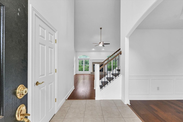 1904 Mullikin Dr, Champaign, IL 61822 - foyer entrance with arched walkways, ceiling fan, stairs, and tile patterned floors