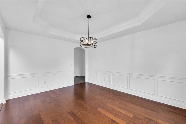 1904 Mullikin Dr, Champaign, IL 61822 - unfurnished dining area featuring arched walkways, a tray ceiling, wood finished floors, ornamental molding, and a chandelier