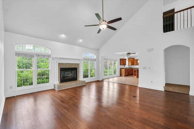 1904 Mullikin Dr, Champaign, IL 61822 - unfurnished living room featuring a ceiling fan, arched walkways, high vaulted ceiling, plenty of natural light, and wood finished floors