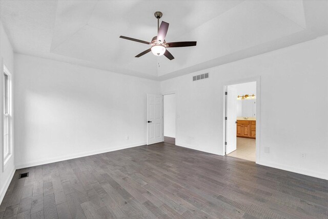 1904 Mullikin Dr, Champaign, IL 61822 - unfurnished bedroom with wood finished floors, a raised ceiling, ensuite bath, and a ceiling fan