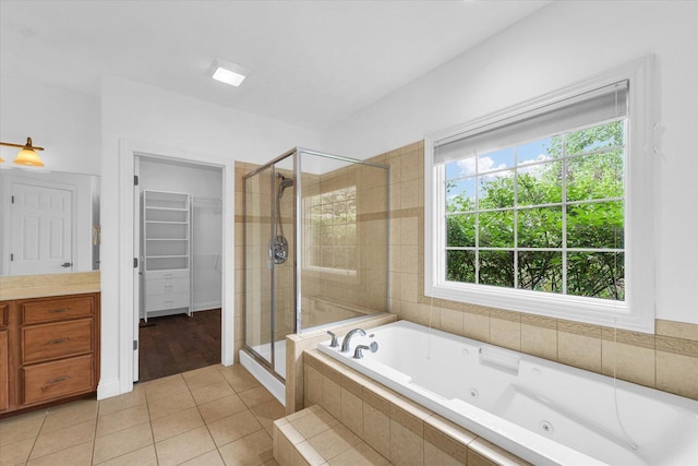 1904 Mullikin Dr, Champaign, IL 61822 - bathroom with a stall shower, a jetted tub, a spacious closet, and tile patterned floors
