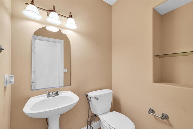 1904 Mullikin Dr, Champaign, IL 61822 - half bathroom featuring toilet and a sink