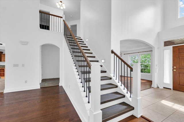 1904 Mullikin Dr, Champaign, IL 61822 - entrance foyer with arched walkways, a towering ceiling, stairway, and wood finished floors