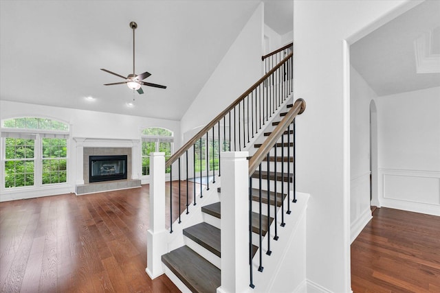 1904 Mullikin Dr, Champaign, IL 61822 - stairs featuring a ceiling fan, wood finished floors, a fireplace, arched walkways, and high vaulted ceiling