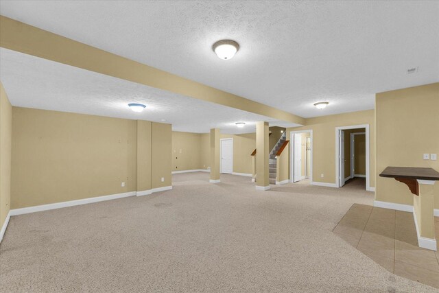 1904 Mullikin Dr, Champaign, IL 61822 - finished below grade area with light carpet, a textured ceiling, and stairs