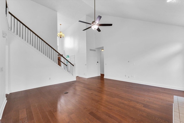 1904 Mullikin Dr, Champaign, IL 61822 - unfurnished living room featuring stairway, a chandelier, ceiling fan, wood finished floors, and high vaulted ceiling