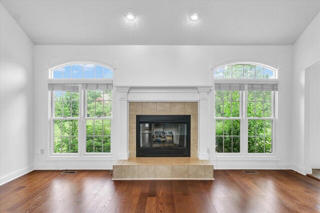 1904 Mullikin Dr, Champaign, IL 61822 - unfurnished living room with hardwood / wood-style flooring and a tile fireplace