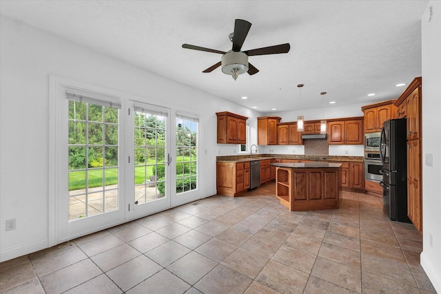 1904 Mullikin Dr, Champaign, IL 61822 - kitchen featuring stainless steel appliances, a kitchen island, brown cabinetry, a ceiling fan, and recessed lighting