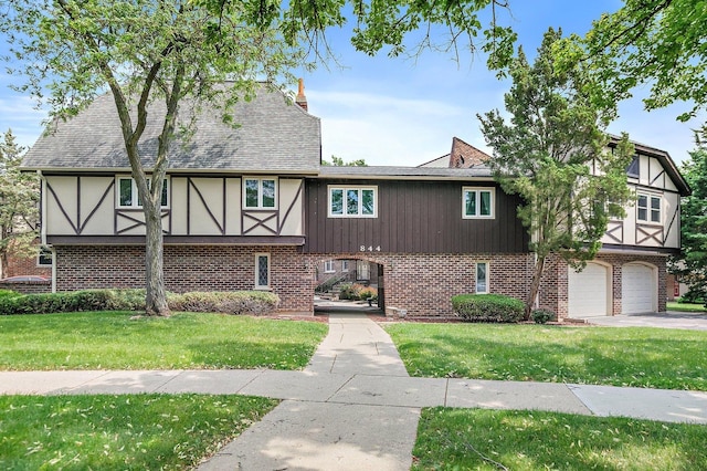 844 Village Quarter Rd Unit A5, West Dundee, IL 60118 - tudor-style house with a front lawn, brick siding, a garage, and stucco siding