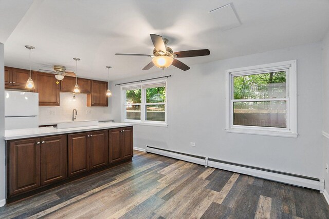 844 Village Quarter Rd Unit A5, West Dundee, IL 60118 - kitchen featuring baseboard heating, freestanding refrigerator, light countertops, ceiling fan, and dark wood-style floors