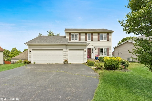 2855 Weld Rd, Elgin, IL 60124 - colonial home with driveway, a front yard, and a garage