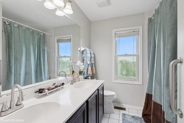 2855 Weld Rd, Elgin, IL 60124 - full bath with healthy amount of natural light, tile patterned floors, double vanity, and a shower with shower curtain